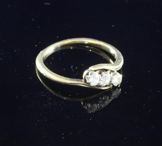 A 18ct gold and three stone diamond ring, size M.